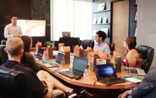 software conversion process - professional talking the client and their team through the process at a meeting